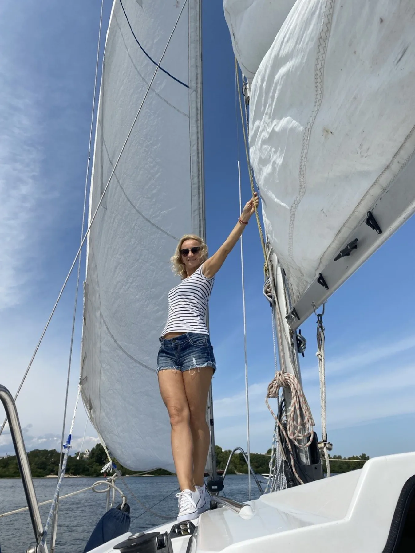 Tatiana standing on a sailboat